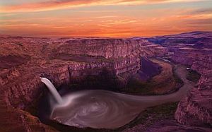 a waterfall at sunset in canyonlands